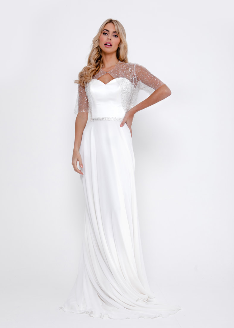 Strapless sweetheart neckline wedding dress with a georgette skirt. Worn with a seqiun tulle bridal shrug