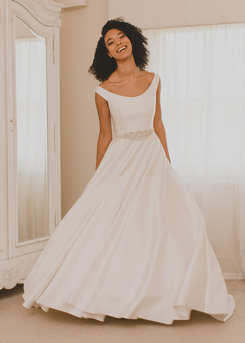 modern ballgown wedding dress with spaghetti straps and a hand painted sillk skit
