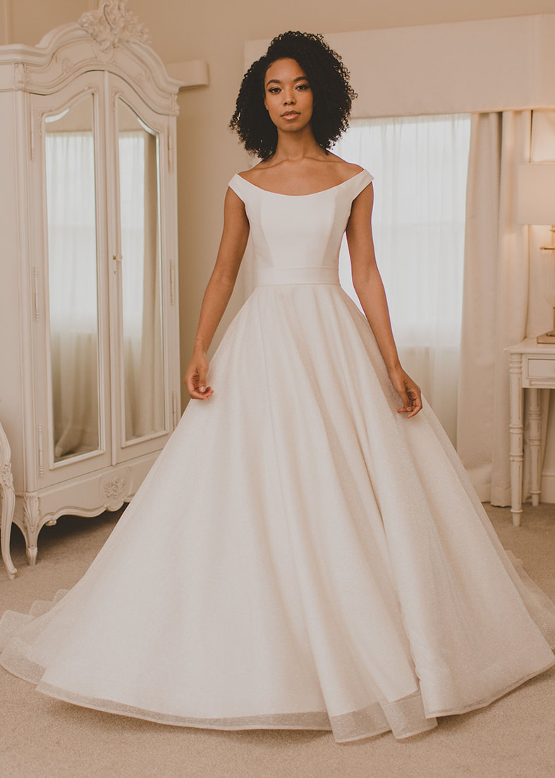Dreamy sparkle tulle over skirt with train worn over a simple strapless wedding dress