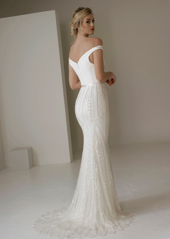 elegant fitted Art Deco inspired wedding gown. Back shot showing puddle train