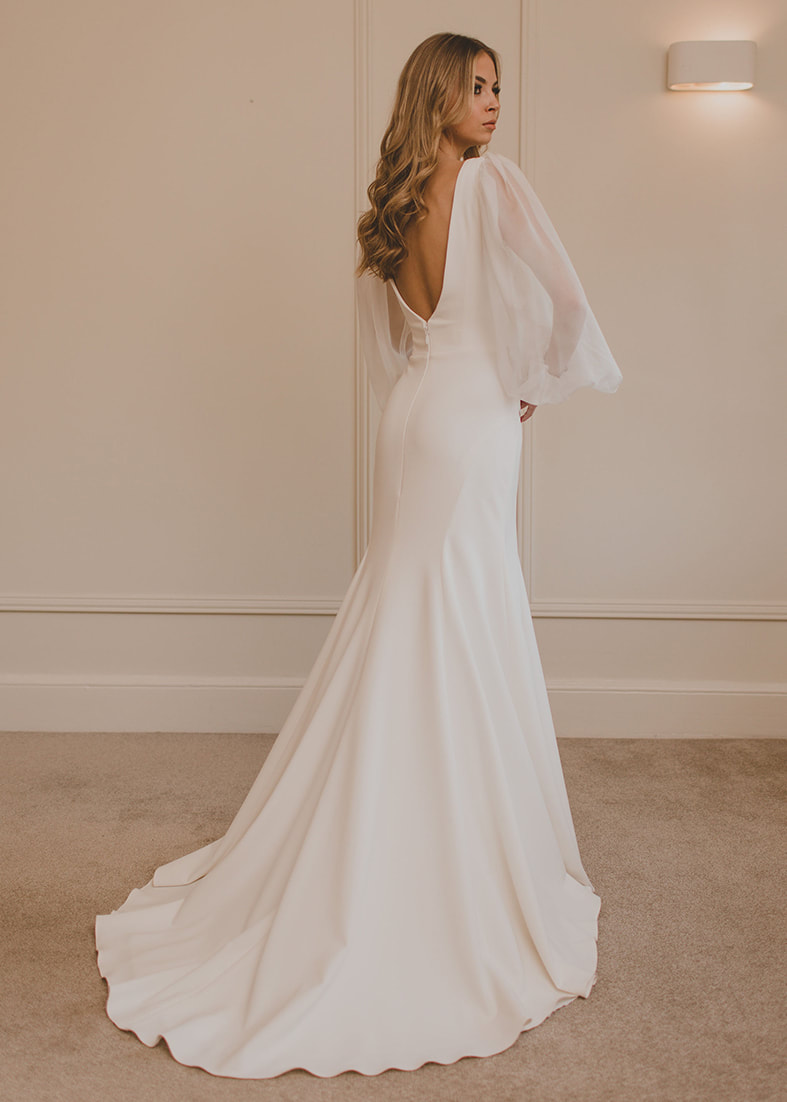 Back shot of the Loren gown showing the deep scoop back. Shown worn with a floral print overskirt 