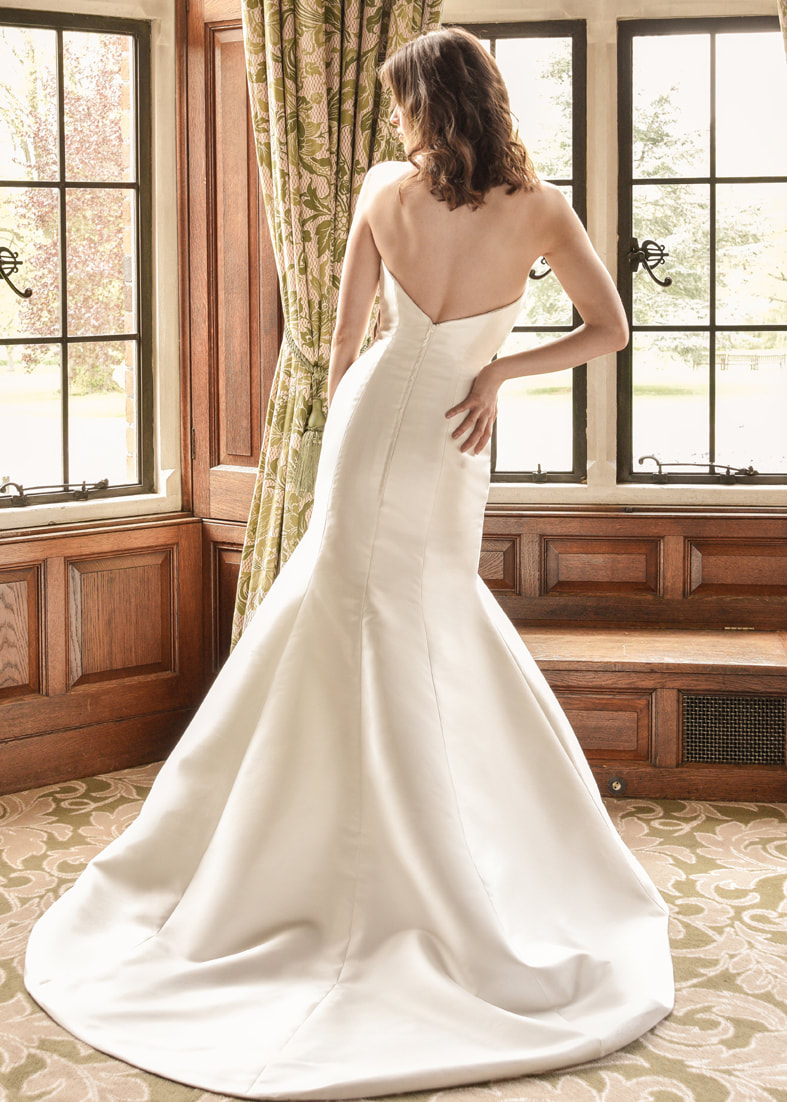 Fitted strapless wedding gown with a button through back detail