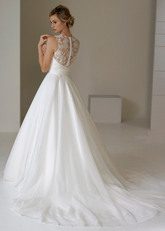 Wedding dress with full skirt, short train and sheer lace back with button detail