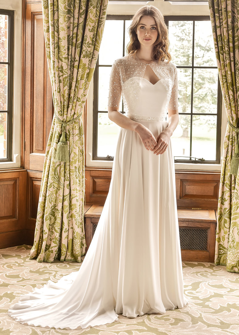 Aphrodite wedding gown with a soft georgette skirt. Shown worn with a beaded tulle shrug with 3/4 length sleeves