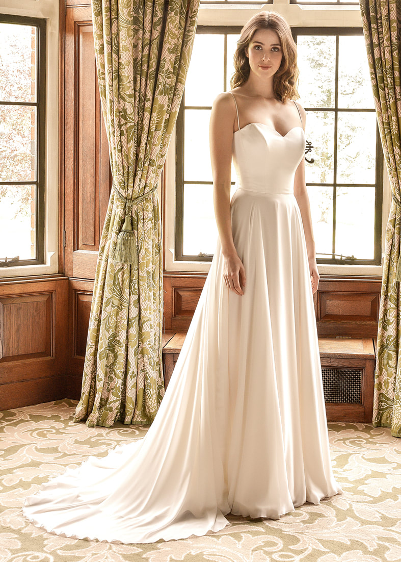 Beautifully simple wedding dress with a satin bodice, a flattering sweetheart neckline, spaghetti straps and a billowing georgette skirt