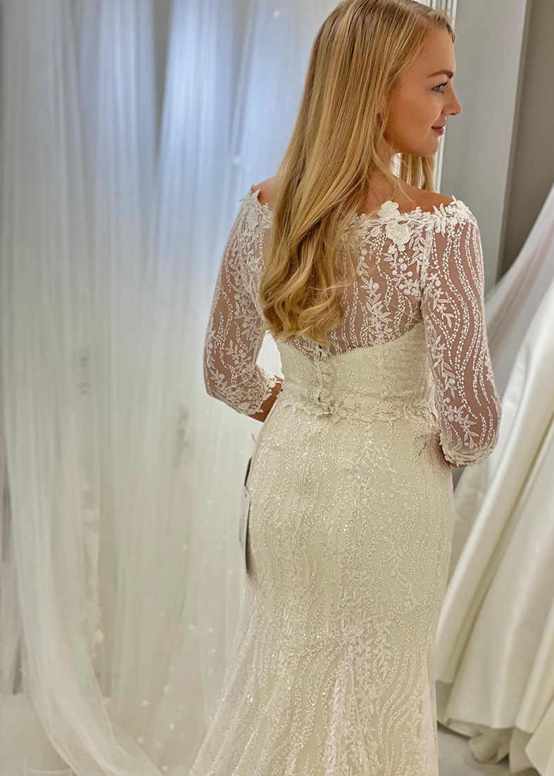Close back shot of the Bacall fit & flare embroidered lace over skirt. Shown worn with the Bacall bridal shrug and Hepburn strapless wedding dress