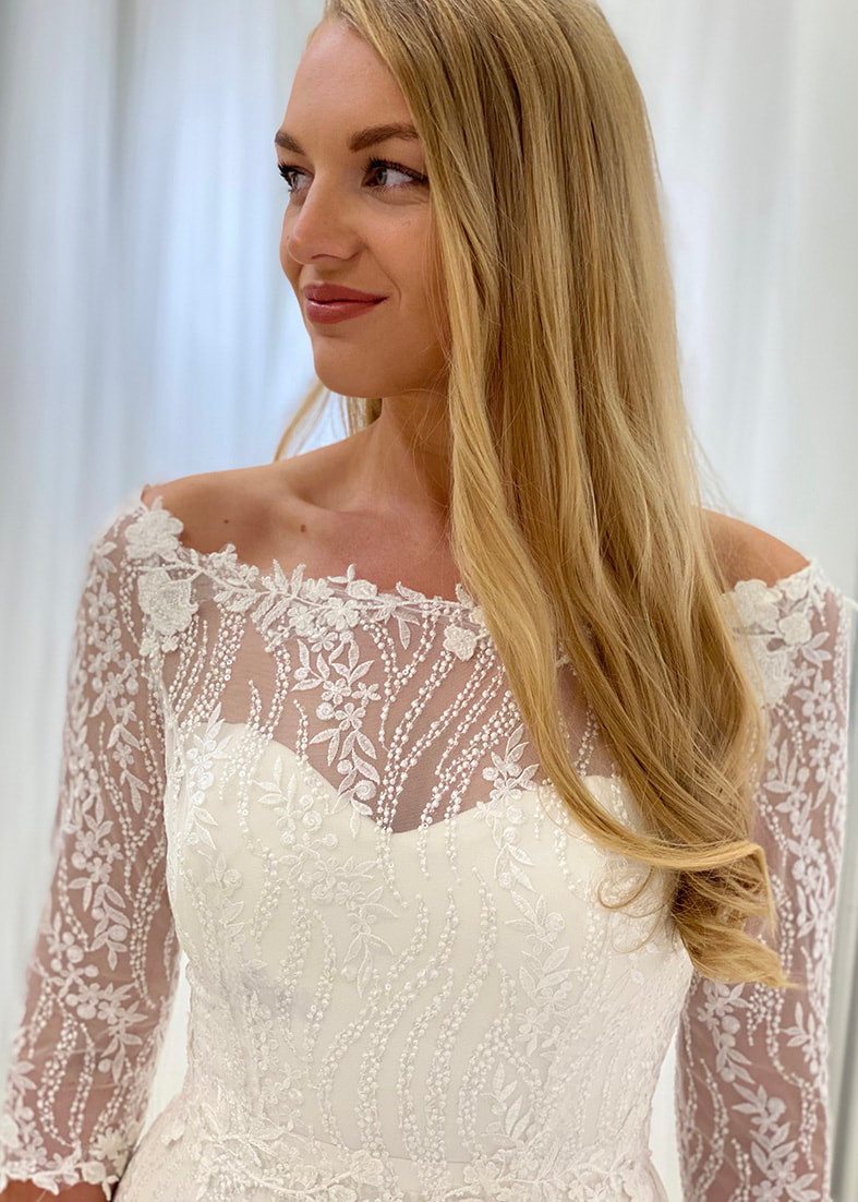 Beautiful off the shoulder shrug with 3/4 length sleeves made from embroidered sequin lace