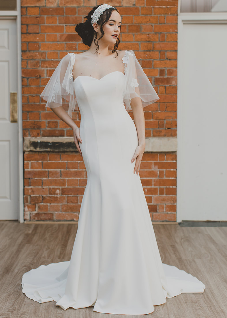 Beloved - fitted strapless bridal gown in a heavyweight crepe. Worn with detachable tulle flutter sleeves