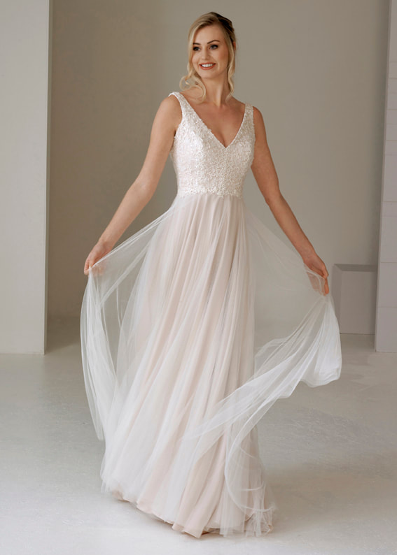 Dreamy v neck wedding dress with a soft tulle skirt in nude tones