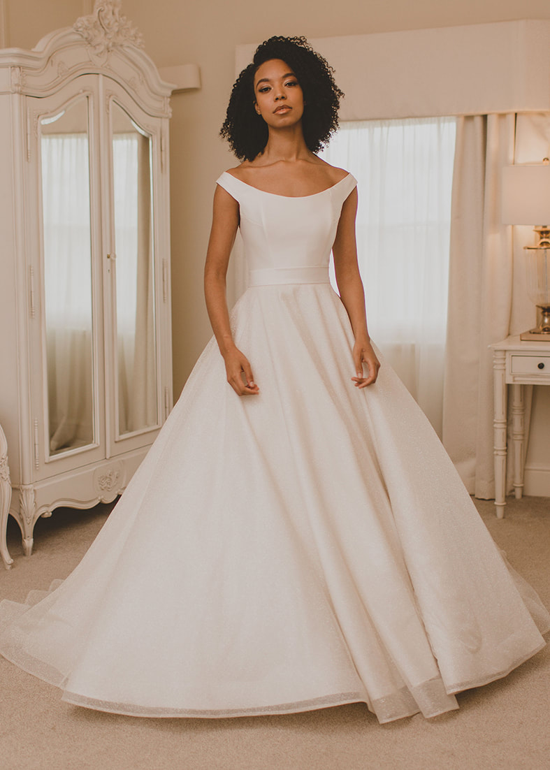 Glitter tulle bridal overskirt shown work over  a strapless wedding dress 
