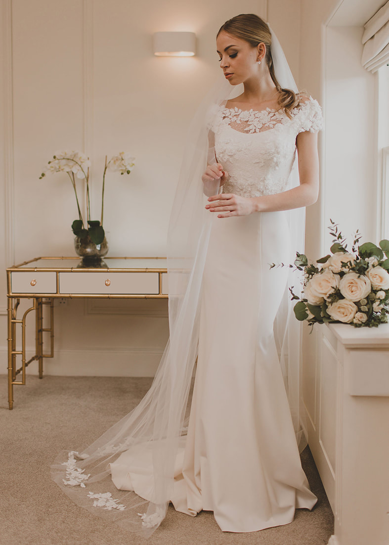 Floor length wedding veil with lace appliques on the train
