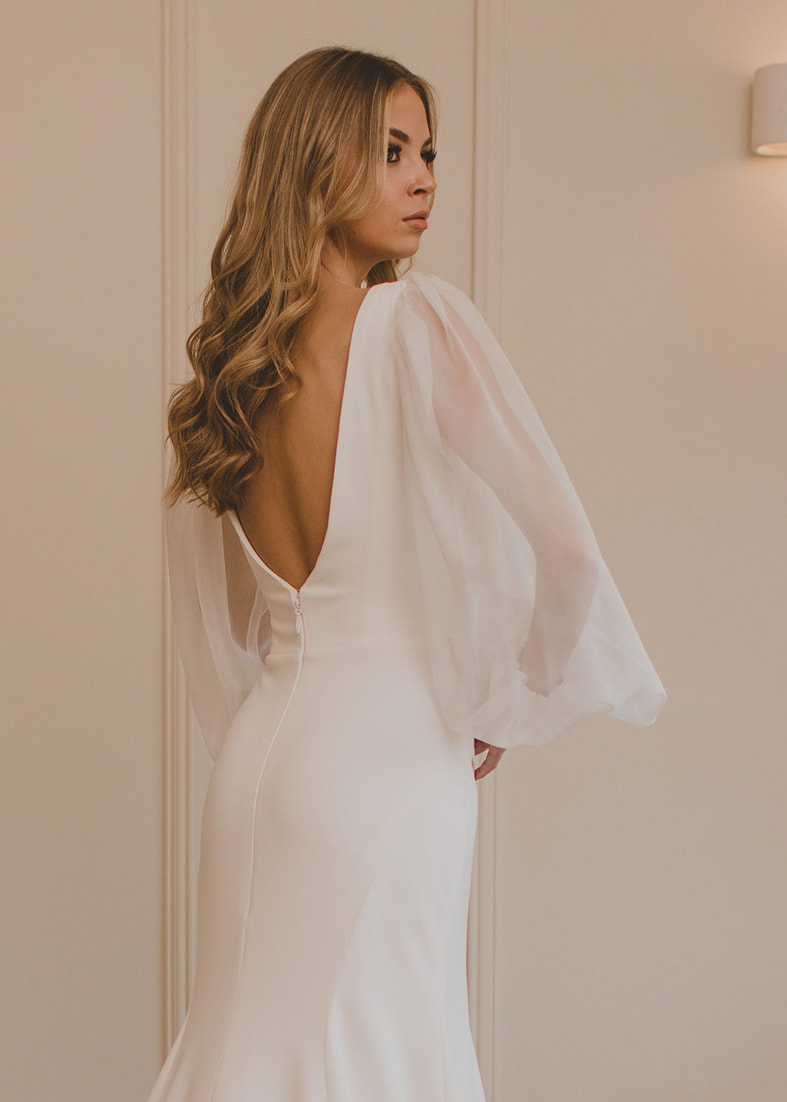 Back shot of the Loren gown showing the deep scoop back. Shown worn with a floral print overskirt 