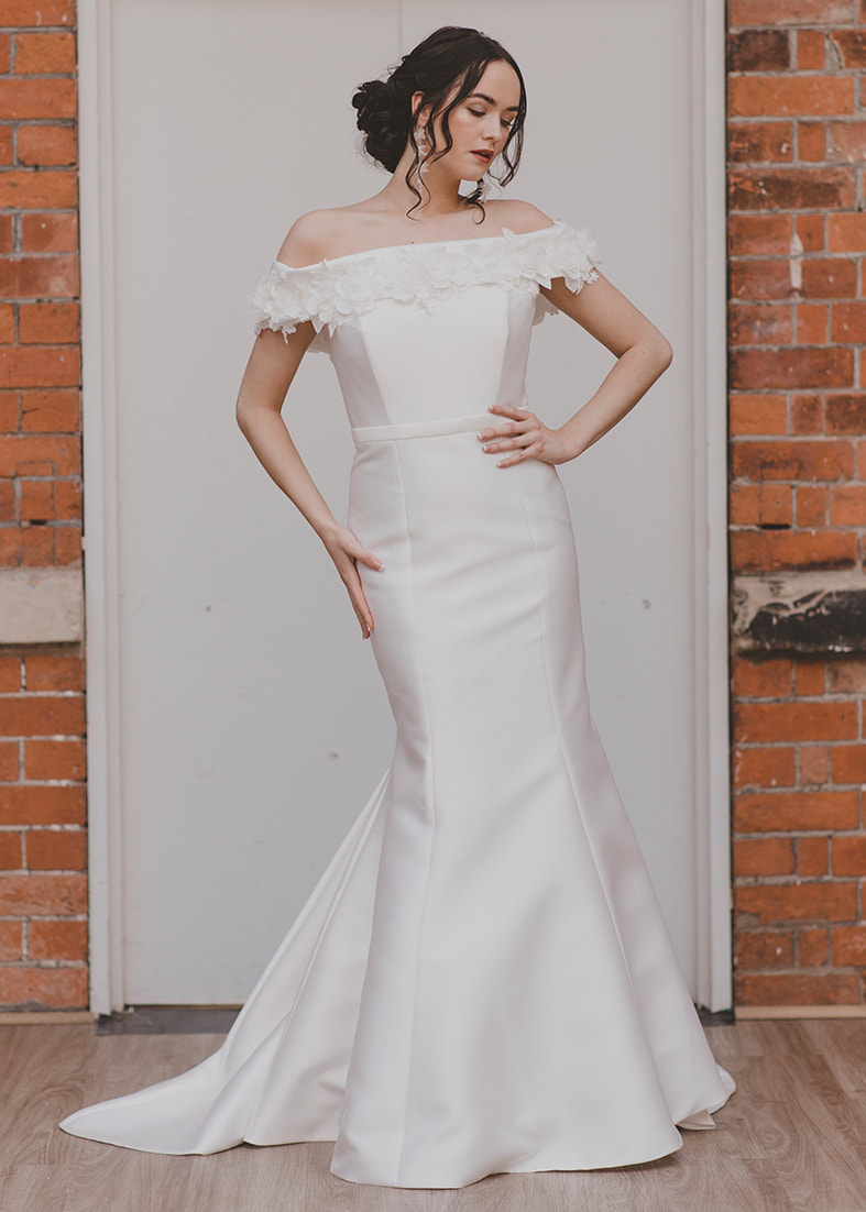 Dreamy - fitted mermaid wedding dress with a wide off the shoulder neckline decorated with floral appliques