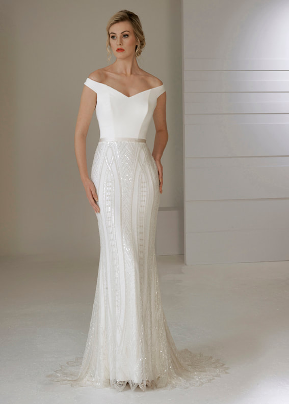 High glamour wedding dress with an off the shoulder neckline and art deco inspired lace overlay