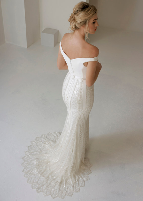 Elegant fitted wedding dress with detailed Art Deco inspired lace skirt 