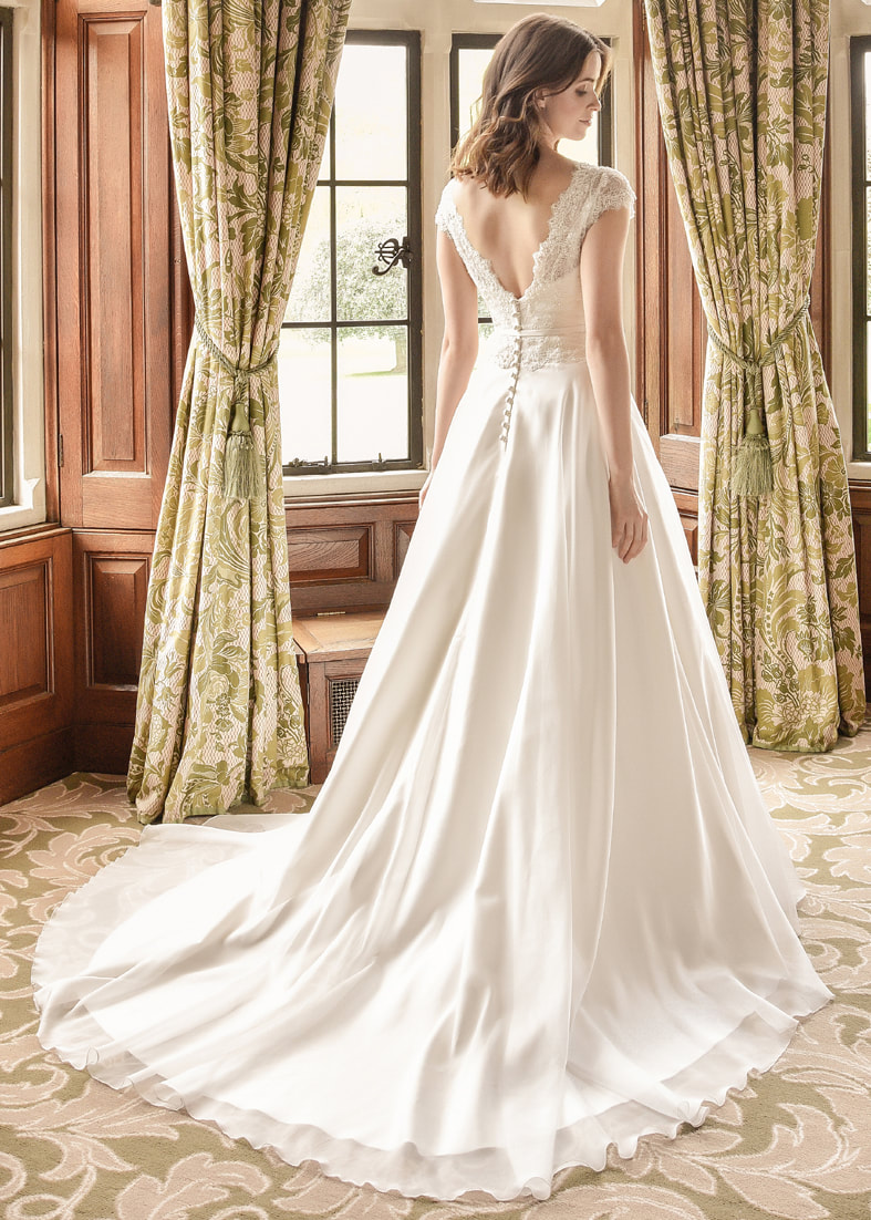 Pretty a line wedding dress with a soft organza skirt flowing into a train and pretty lace detailing on the neckline