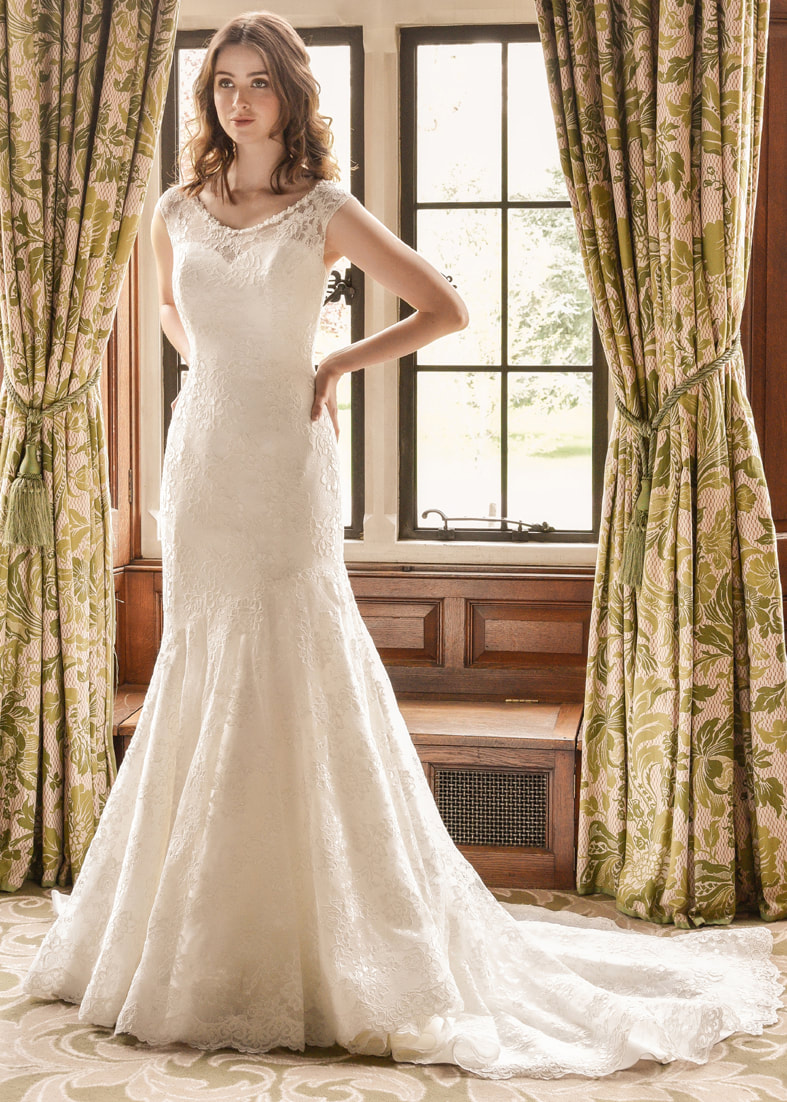 Fishtail lace wedding dress with a sheer neckline and small train