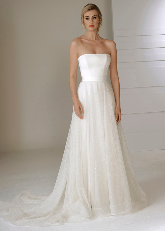 Dreamy sparkle tulle over skirt with train worn over a simple strapless wedding dress