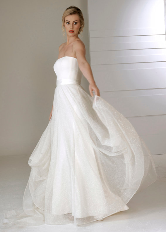 Floaty bridal over skirt worn with a strapless wedding dress