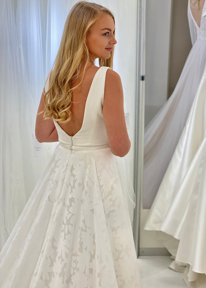 Beautiful floral printed bridal overskirt shown worn over a sleeveless low backed gown