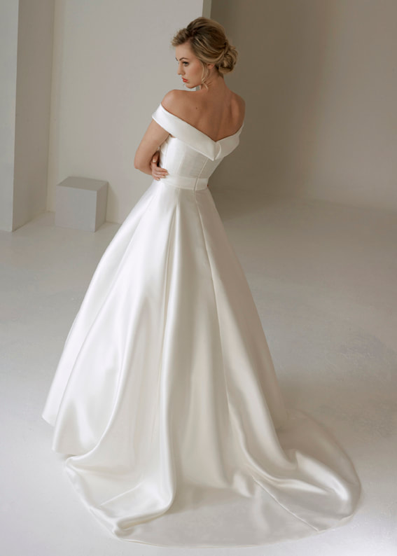 Modern full skirted wedding dress with a train and off the shoulder straps. Back view