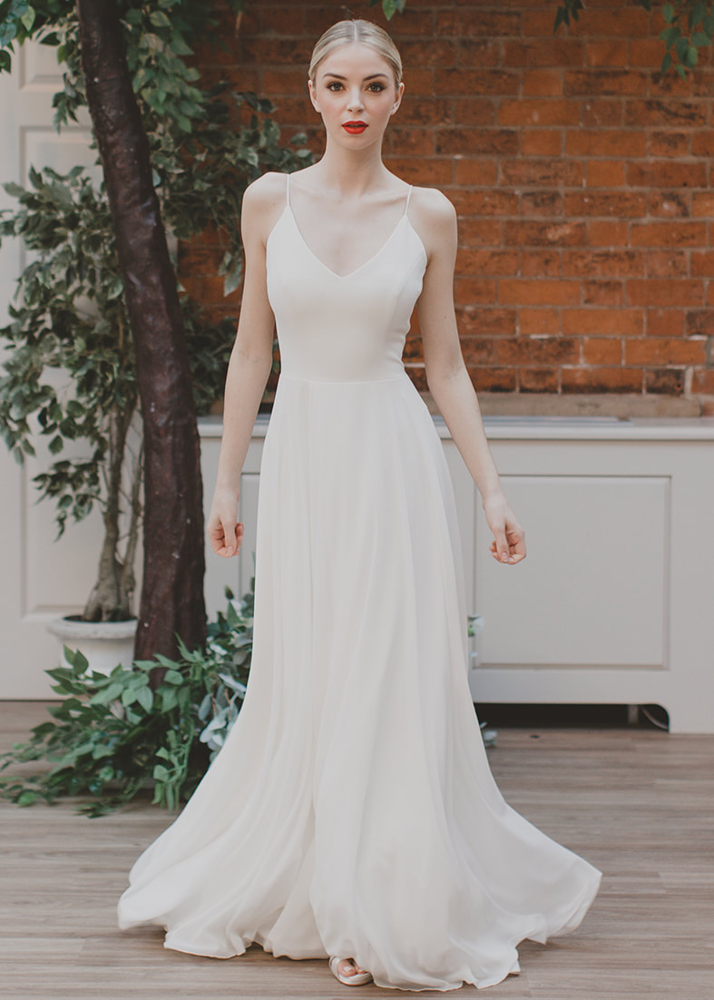 Heartfelt - modern georgette and crepe wedding gown with spaghetti straps, a v neckline and flowing circle skirt