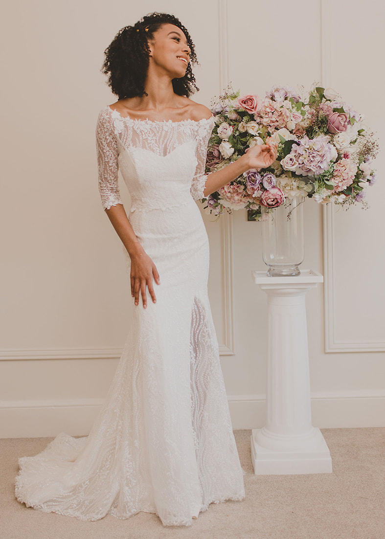 Fit & Flare bridal overskirt in an embroidered sequin tulle. Shown worn over a fitted strapless wedding dress with thigh split
