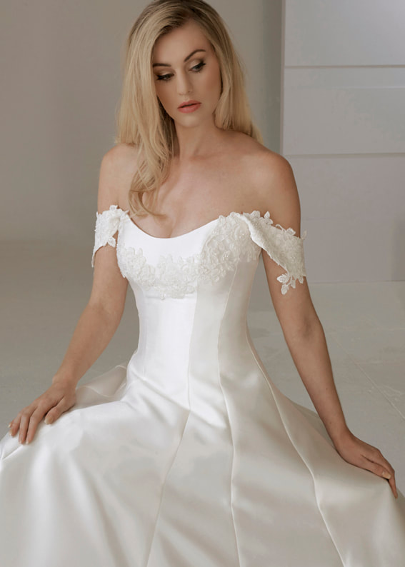 Off the shoulder wedding gown embellished with guipure lace and seed pearls 