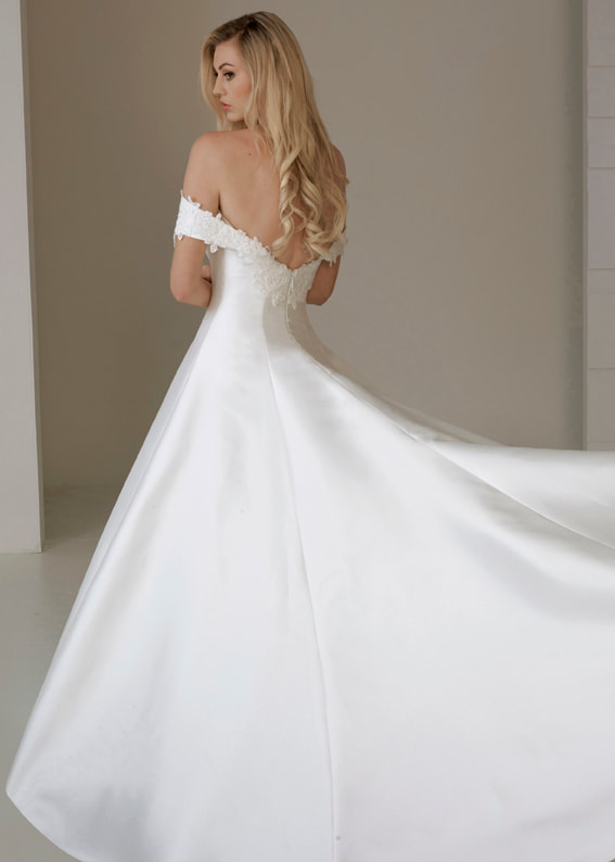 Princess line wedding dress with train and off the shoulder sleeves. Back shot