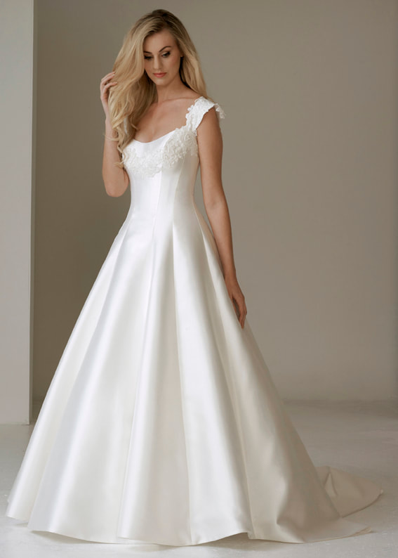 Princess line wedding dress with wide straps. The straps and neckline are adorned with guipure lace and seed pearls 