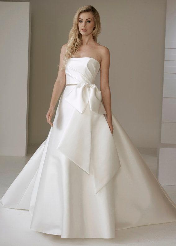 Contemporary strapless wedding dress with oversize bow detail