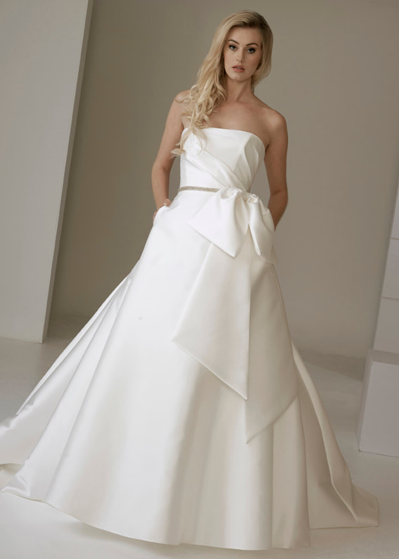 Modern strapless ballgown wedding dress with pockets and oversize bow