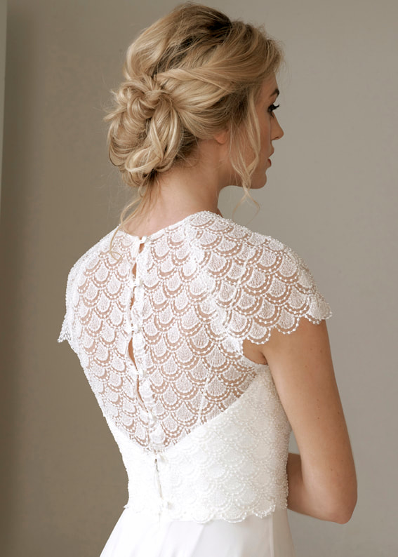 Ornate lace bridal shrug with back buttons. Back image