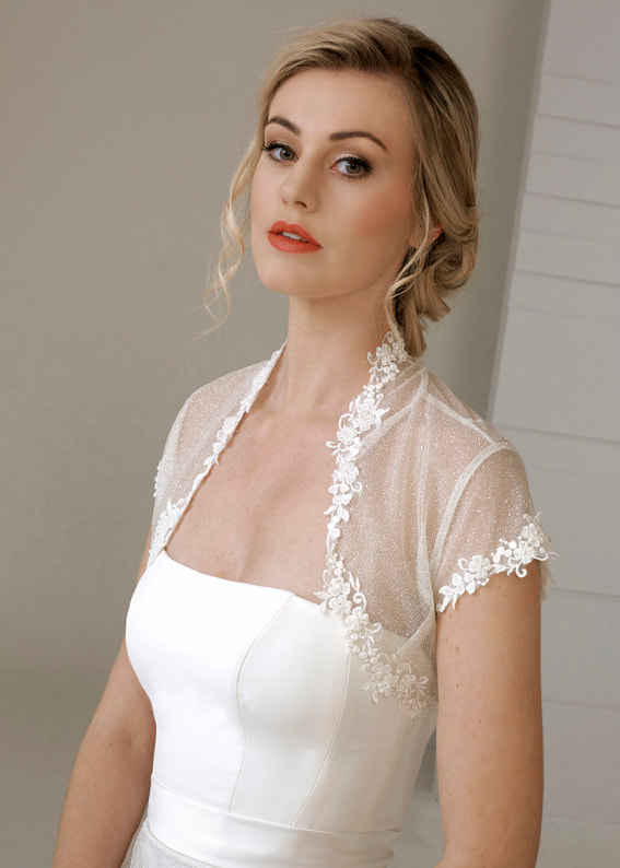 Short sleeve brudal shrug / jacket in sparkle tulle edged with a delicate floral lace trim