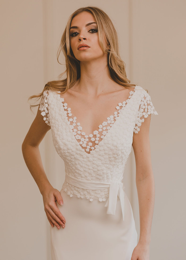 Modern back fastening bridal shrug in all over embroidered daisy fabric