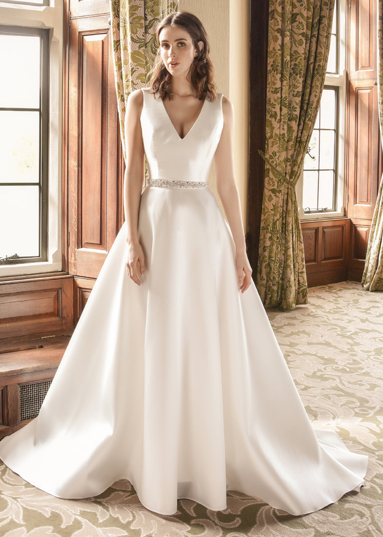 Modern A-line wedding dress in Mikado with a low v neckline and beaded crystal waist detail
