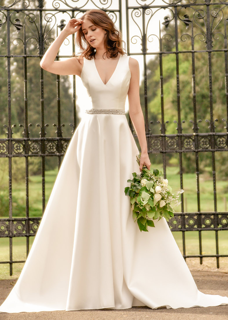 Elegant v neck wedding dress with full skirt and diamante waist detail