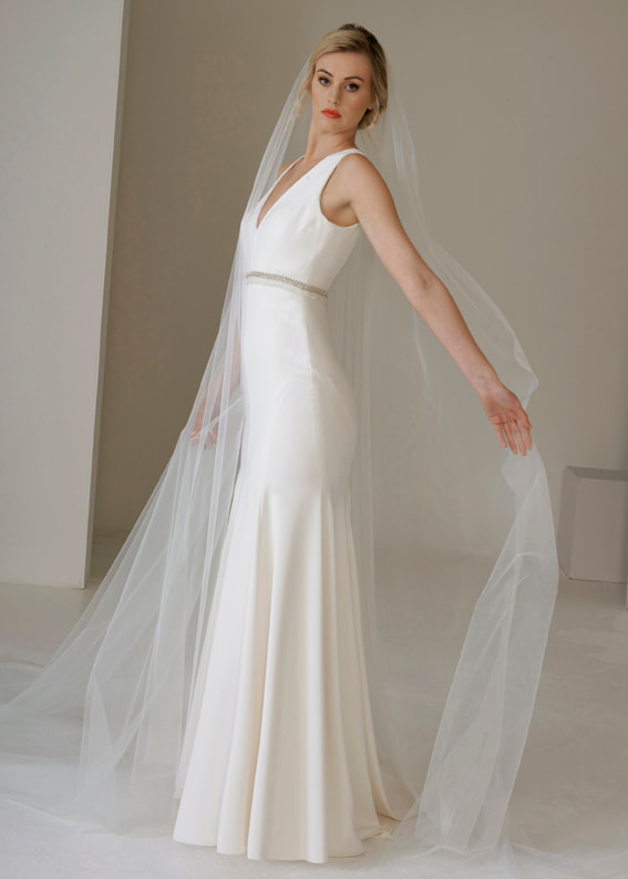 Elegant v neck Art Deco style wedding dress with a beaded trim at the bust