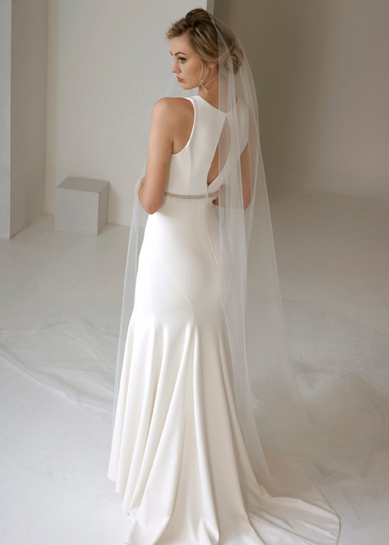Stunning art deco style fitted gown with an elegant keyhole back design. Shown worn with sweeping veil