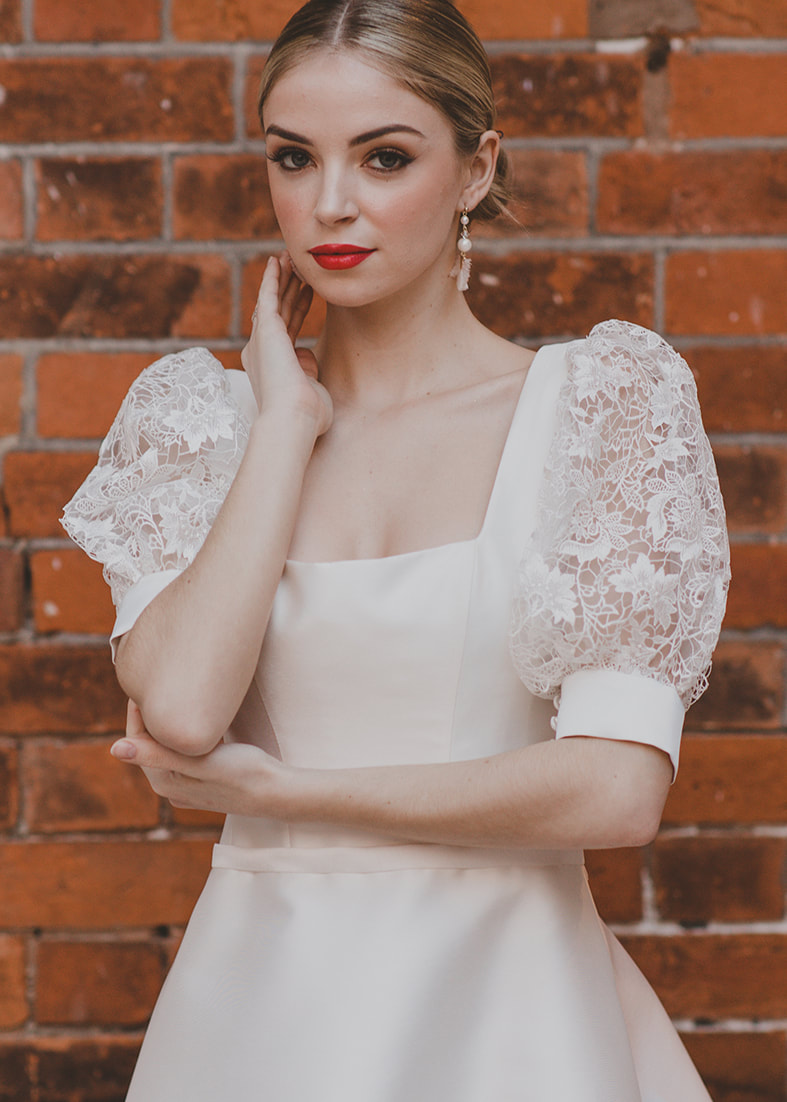 Sensual Lace Sleevs - Above the elbow detachable puff sleevs in guipure lace with a wide satin cuff and button detail. Worn ith a satin wedding dress with a square neckline and wide straps