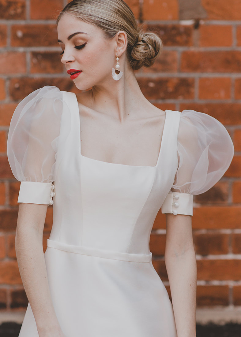 Sensual Organza Sleeve - detachable short puff sleeves in organza with a wide satin cuff with button details. Worn with a satin wedding dress with a square neckline and wide straps