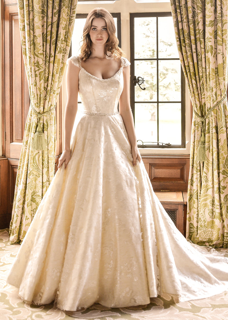 Regal brocade wedding dress with a full ballgown skirt and scoop neckline